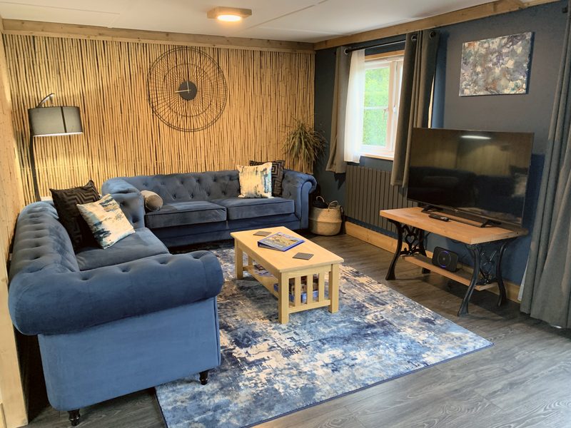 Lounge with velvet sofas and smart TV