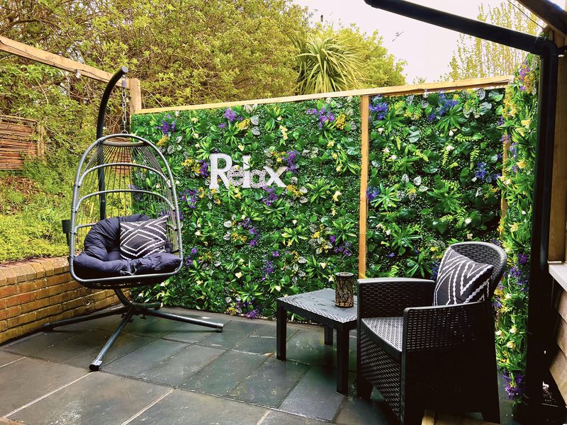 Seating beside the hot tub, with a hanging egg chair